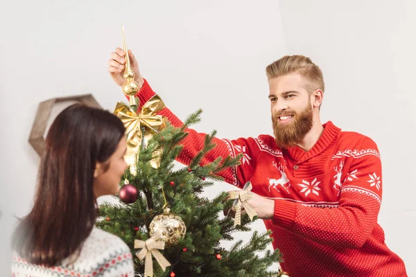 Couple decorating christmas tree — Stock Photo, Image