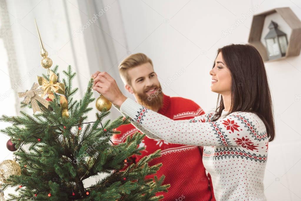 couple decorating christmas tree