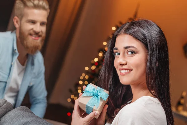Man presenting christmas gift to girlfriend — Free Stock Photo