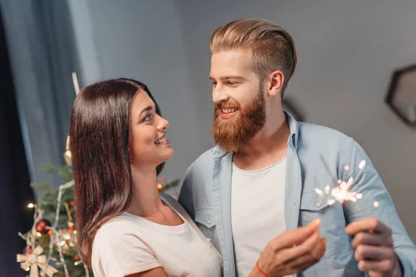 Young couple with sparklers — Stock Photo, Image