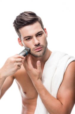 man shaving with electric trimmer