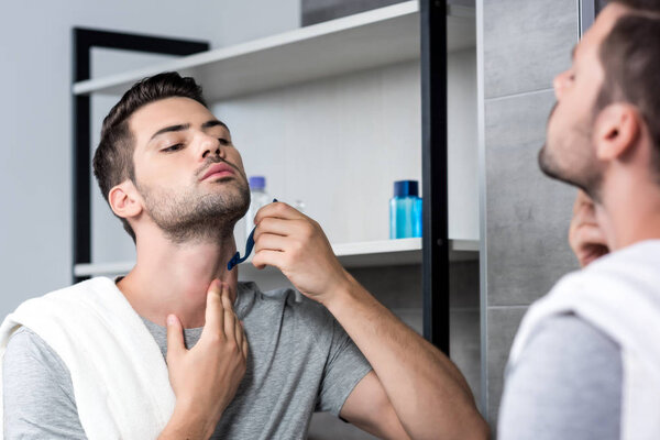 young man shaving