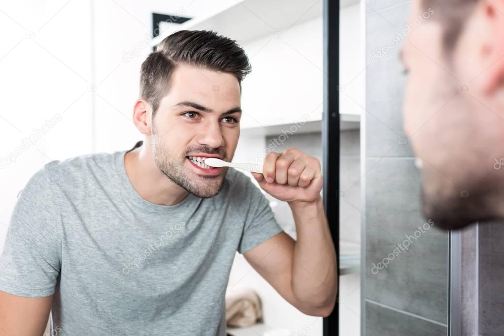 man brushing teeth