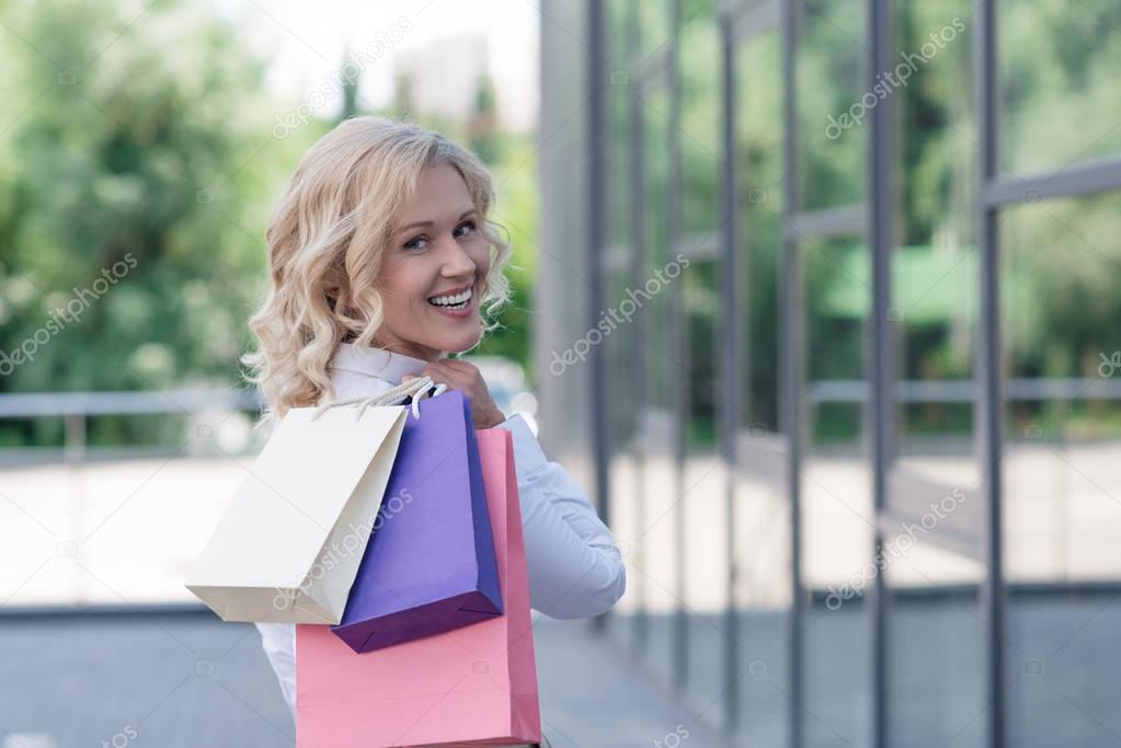 smiling woman with shopping bags