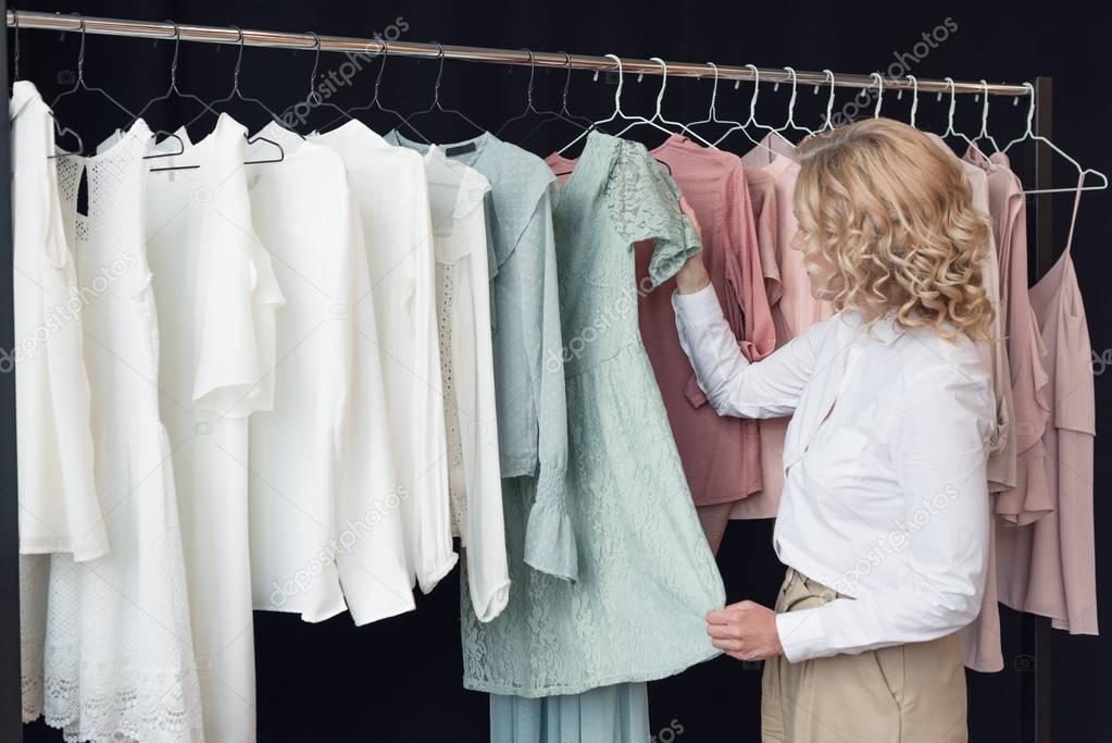 woman choosing clothes in clothing store