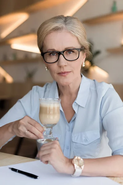 Olgun bir kadın kahve içiyor. — Stok fotoğraf