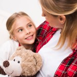 Mother and daughter with teddy bear