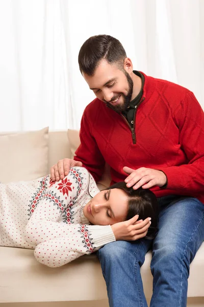 girl sleeping on knees of boyfriend