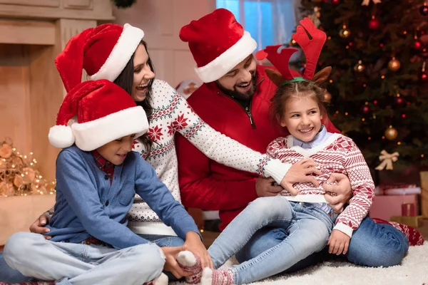 Happy family in santa hats — Stock Photo, Image