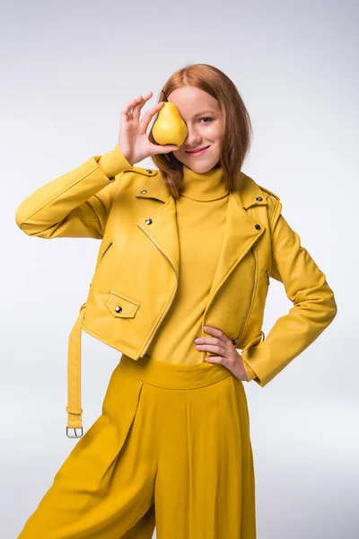 Stylish girl in yellow with pear — Stock Photo, Image