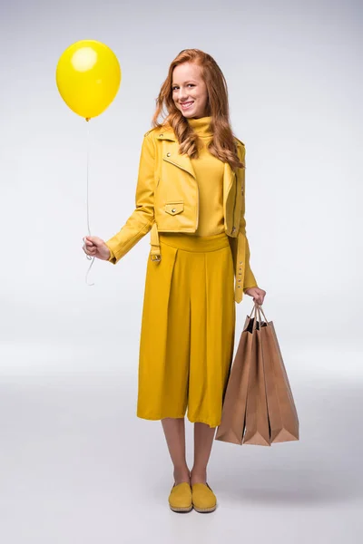 Girl with shopping bags and balloon — Stock Photo, Image