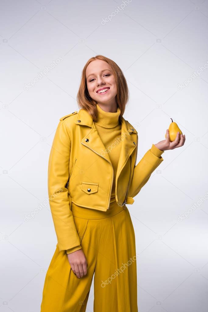 girl in yellow clothes with pear
