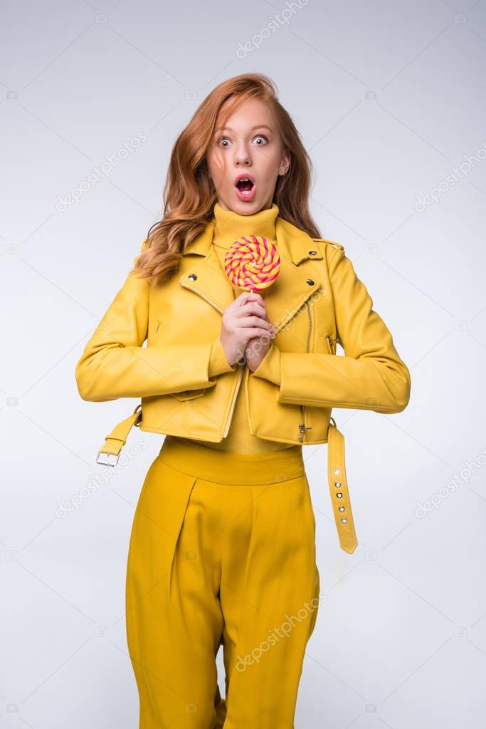shocked girl in leather jacket with lollipop