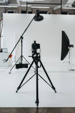 camera in photo studio with lighting equipment clipart