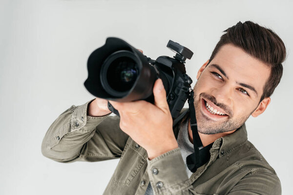 smiling photographer with digital camera