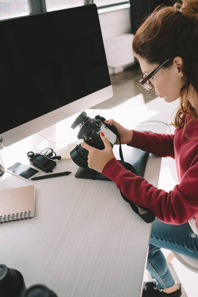 photographer with digital camera in office