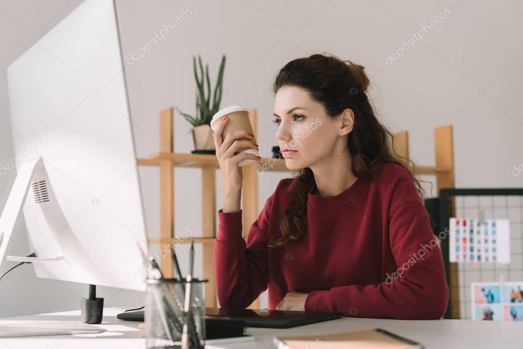 designer with coffee working in office