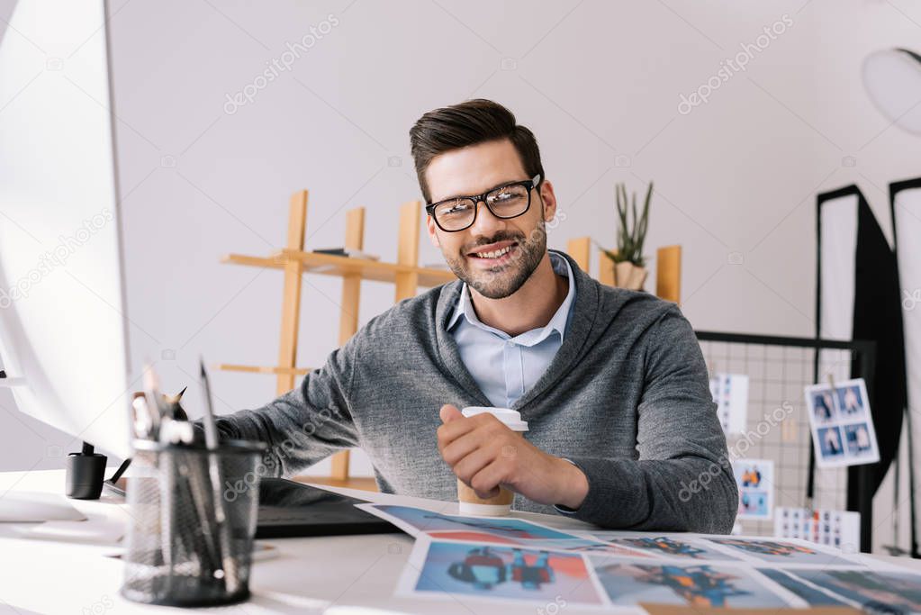 photographer with graphics tablet and photos