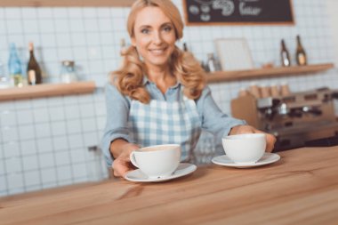 waitress holding cups of coffee  clipart