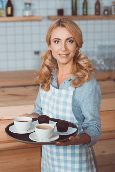 waitress with utensils and tray