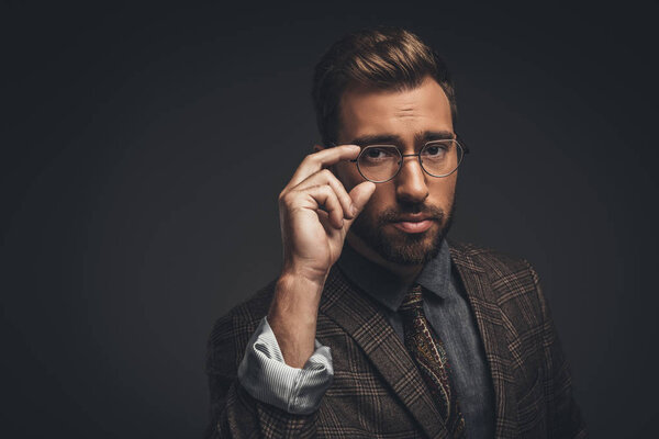 man adjusting glasses