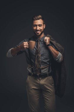 Handsome man holding cup of coffee clipart