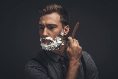 man shaving with straight razor clipart