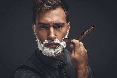 man shaving with straight razor clipart
