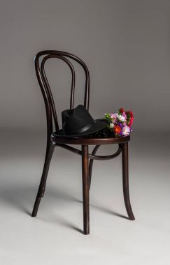 Wooden chair with hat and flowers clipart
