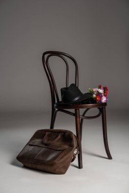 Wooden chair and leather bag clipart