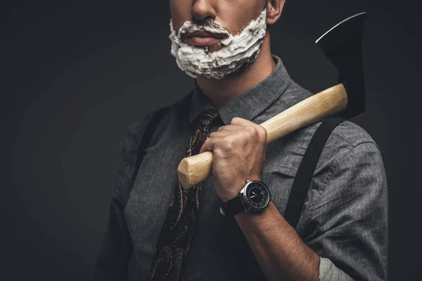 Man in shaving cream holding axe — Stock Photo, Image