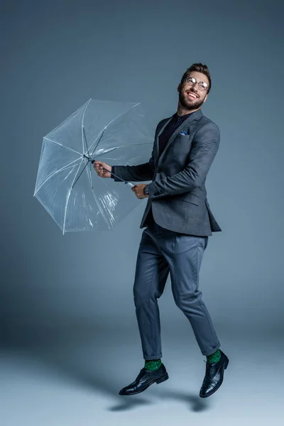 Man in suit with umbrella — Stock Photo, Image