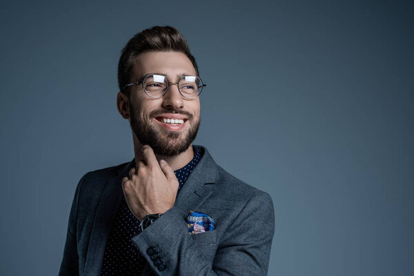 man in suit scratching beard