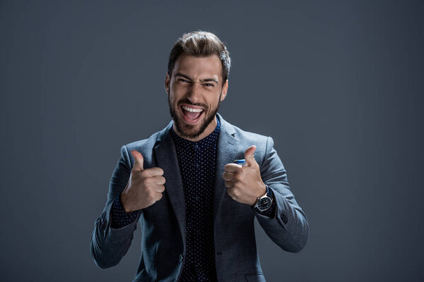 Man in suit showing thumbs up