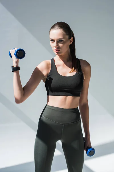 Athletic girl with dumbbells — Stock Photo, Image