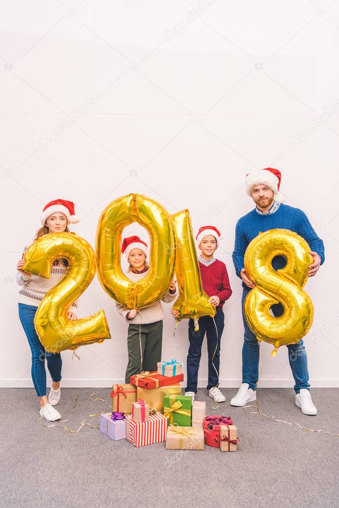 family holding new year balloons