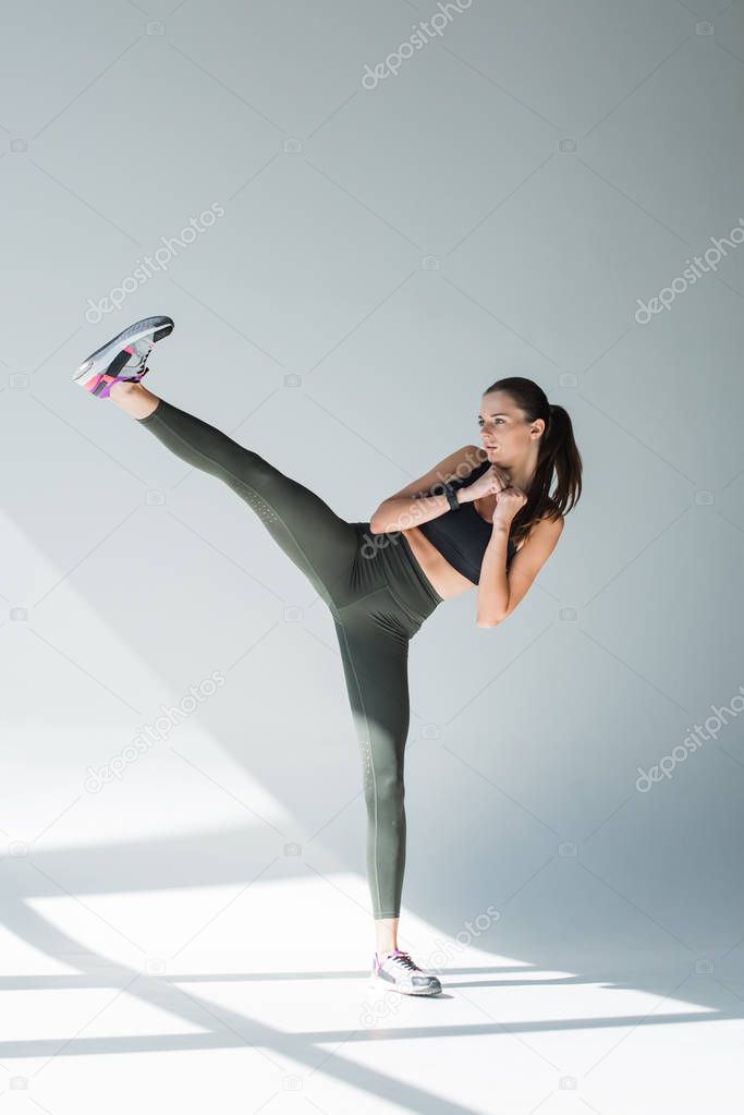 sportswoman doing side kick 