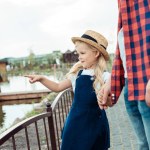 Kid pointing at pond