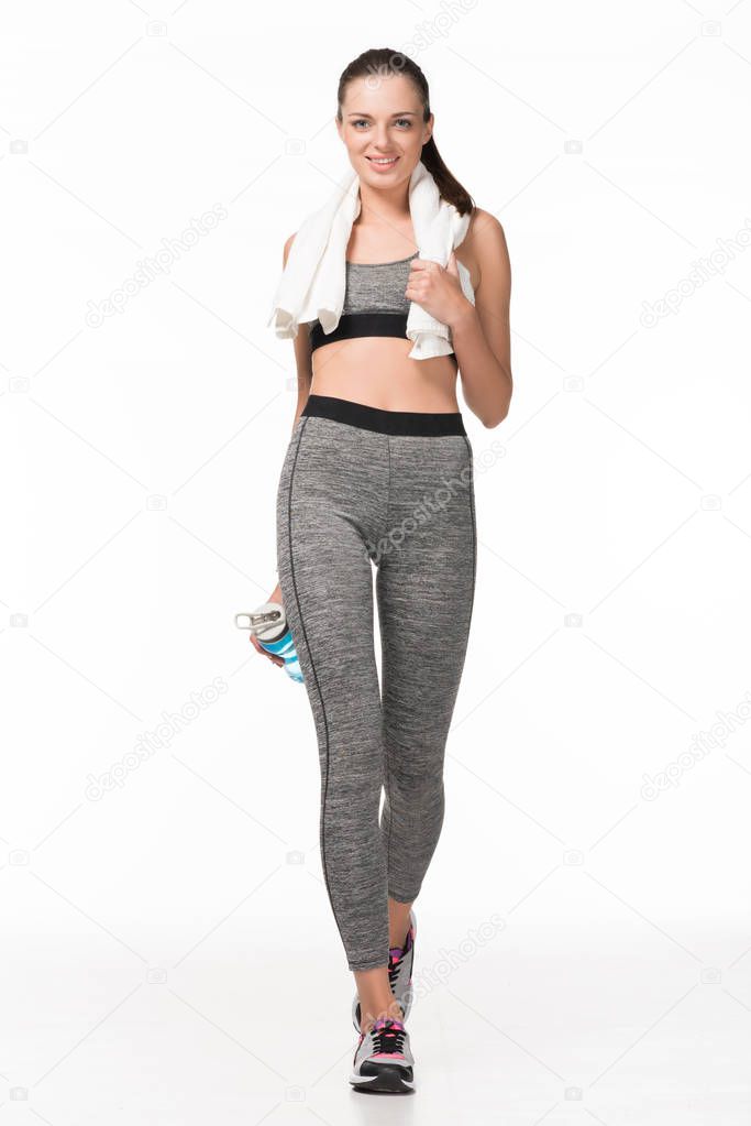 sportswoman with towel and bottle of water