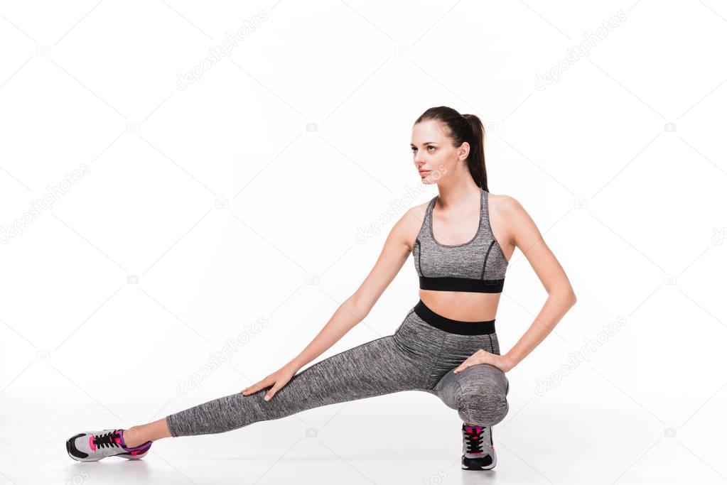 sporty woman stretching legs