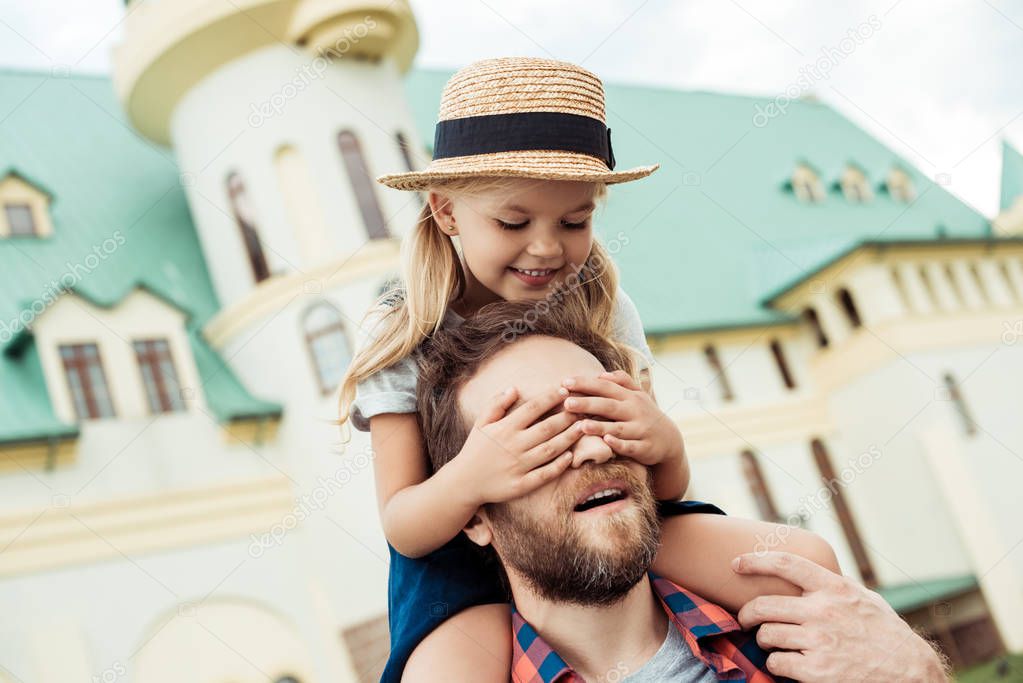 father and daughter piggybacking together