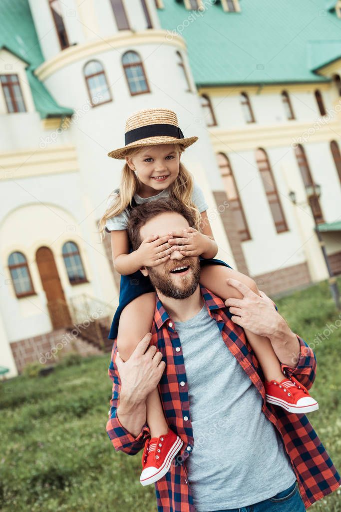 father and daughter piggybacking together