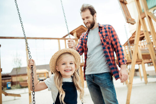 child swinging on swing