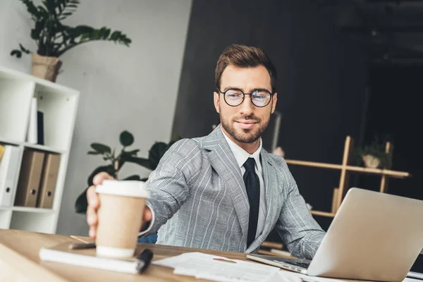 Tek kullanımlık bardak kahve alarak iş adamı