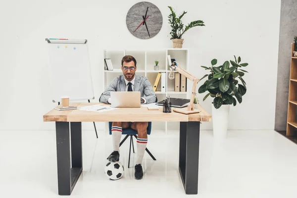 Businessman in soccer shoes with ball — Stock Photo, Image