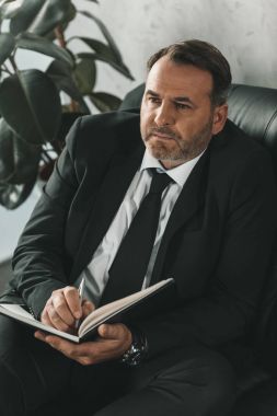 Defterde yazan iş adamı