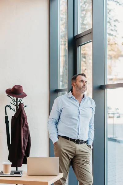 Businessman looking through window