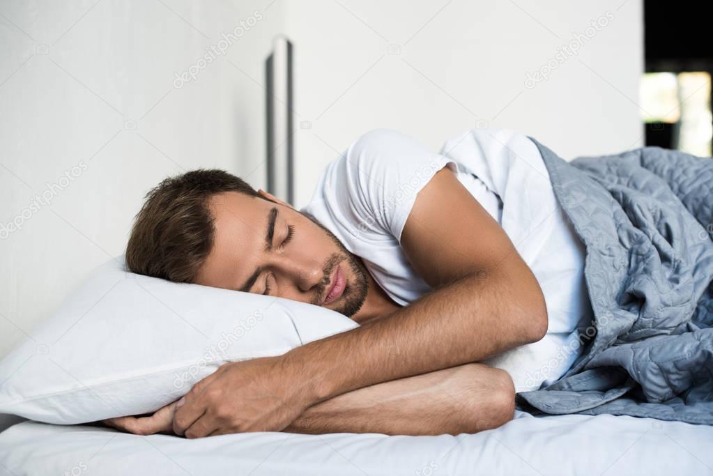 man sleeping in bed 