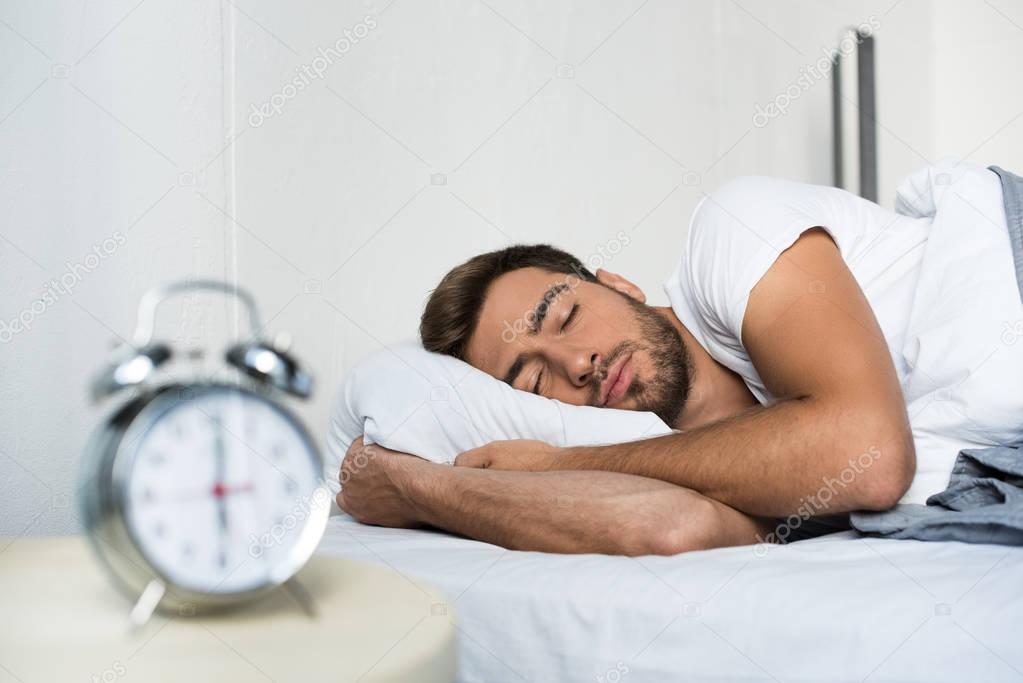 man sleeping in bed 