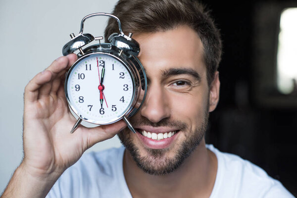 man with alarm clock
